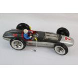 Japanese Jyese tin plate battery powered F1 racing car in two tone grey, race number 7, driver
