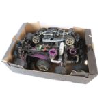 A collection of four Nitro remote control car chassis for spares to include 2 engines, one being a