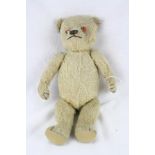 Early to mid 20th C straw filled teddy bear with growler, showing wear