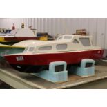 Wooden scratch built model boat with motor, painted red, black and white, approx. 29" in length