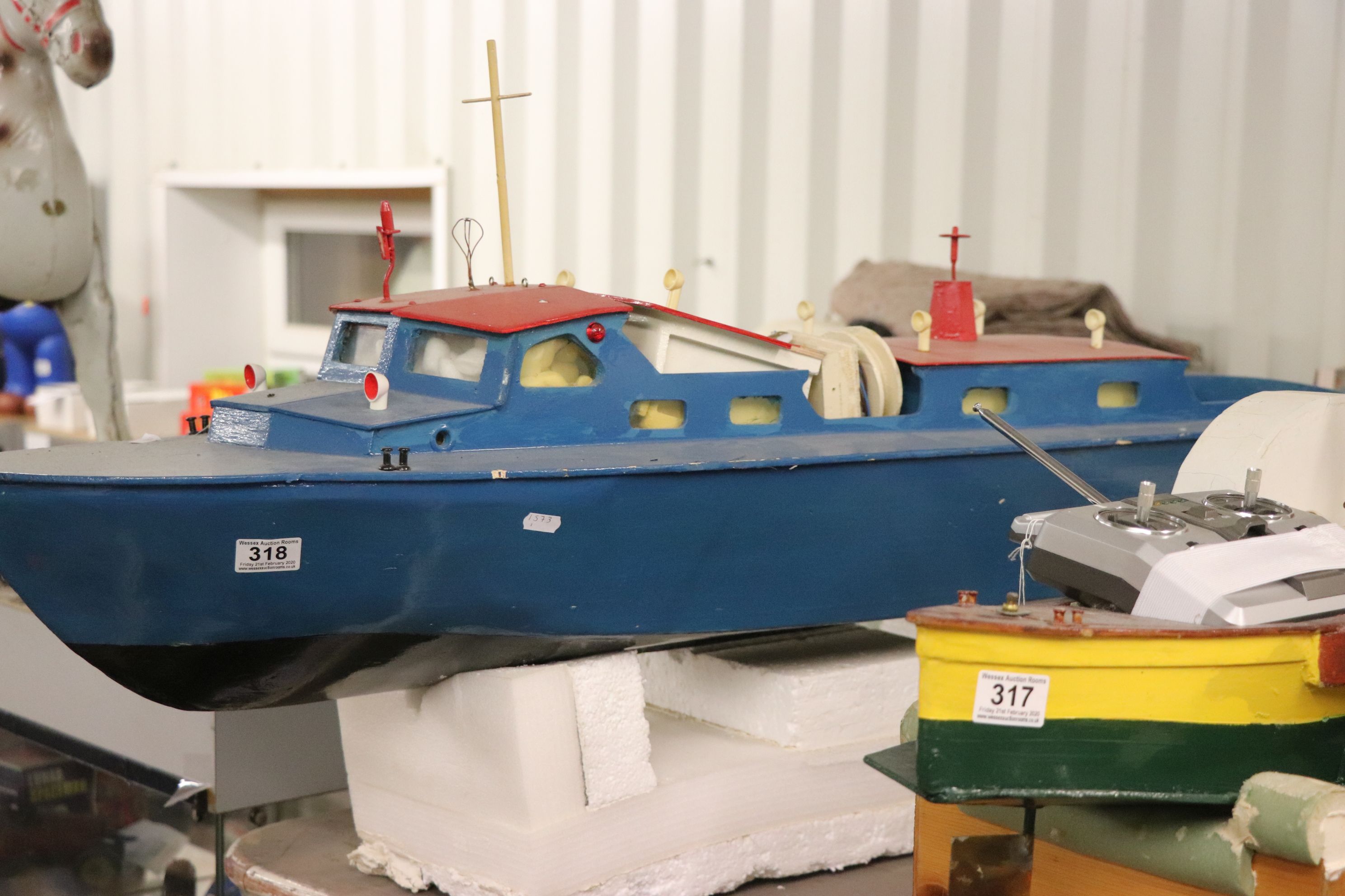 Large wooden radio controlled boat painted blue and red, approx. 45" in length