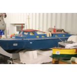 Large wooden radio controlled boat painted blue and red, approx. 45" in length