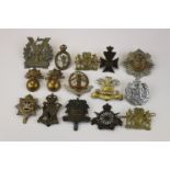 A Collection Of 15 British Military Cap Badges To Include The Royal Marine Artillery, The Tyneside