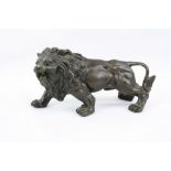 Filled Bronze model of a Lion with patinated finish, approx 15.5cm long