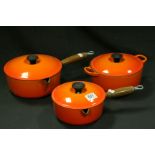 Le Creuset - two lidded saucepans and a lidded casserole dish