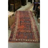Middle Eastern Red Ground Wool Rug with Geometric Pattern surrounded by a Panel, 292cms x 124cms