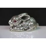 Silver rabbit paperweight with ruby eyes