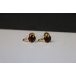 A pair of 9ct Gold and Garnet set screw back earrings.