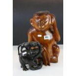 Treen carved wood sculpture of a chimpanzee monkey, together with an ebonized wooden sculpture of an