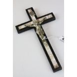 A 20th century wooden and white metal crucifix with mother of pearl inlay.