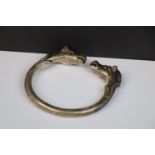 A vintage white metal open ended bangle with horse head decoration, stamped TU.