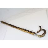 A antique malacca silver mounted walking stick with horn handle and one other walking stick.