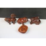 Four miniature wooden netsukes to include a horse, dog, rabbit and Buddha's face.