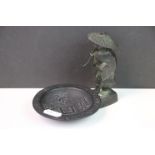 Bronze oriental figure, together with a cast iron Chinese pin dish with character marks