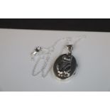 Silver photo locket with embossed cat set with emerald collar and ruby eyes