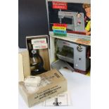 Boxed Vulcan Classic Child's Electric Sewing Machine plus a boxed Merit Students Microscope No 3/