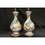 *Pair of hand painted Glass Lamps with Rose decoration & signed "G.W", each approx 41.5cm tall