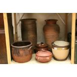 Oriental terracotta lidded pot, a similar stoneware pot, a stoneware crock, a balustre shaped