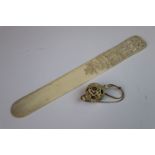 An Antique Japanese ivory page turner with a finely carved handle together with an antique carved