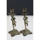 Pair of Brass Cherub candlesticks, 22cms high