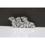 Silver brooch with three dogs