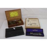 A tray of collectables to include a drawing set and a set of brass balance scales within original