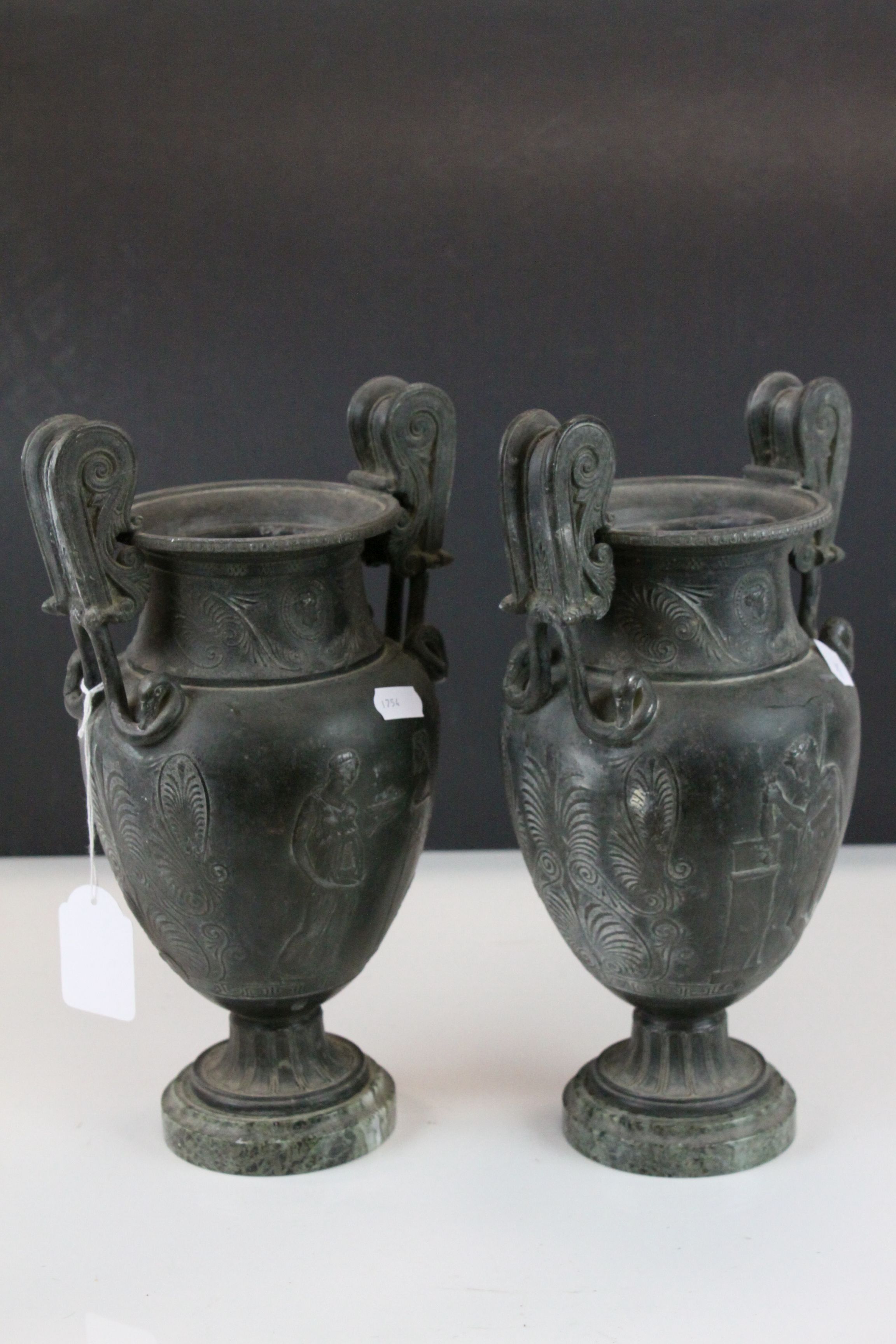 Pair of 19th century Cast Classical Twin Handled Urns on Green Marble Bases, 28.5cms high