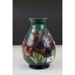Walter Moorcroft Green Ground Orchid Pattern Vase, paper label ' By appointment, potters to the late