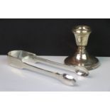 Pair of silver sugar tongs and a silver candleholder
