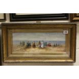 Gilt framed oil painting of a beach scene view with Victorian beach gathering