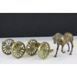 Two vintage brass cannons and a horse