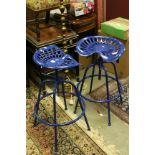 Pair of Contemporary Adjustable Blue Painted Metal Stools, the seats formed from Vintage Tractor