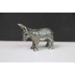 A silver model of a donkey with a glass eye