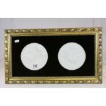 Pair of Royal Copenhagen Parianware plaques mounted in a single frame, with classical decoration
