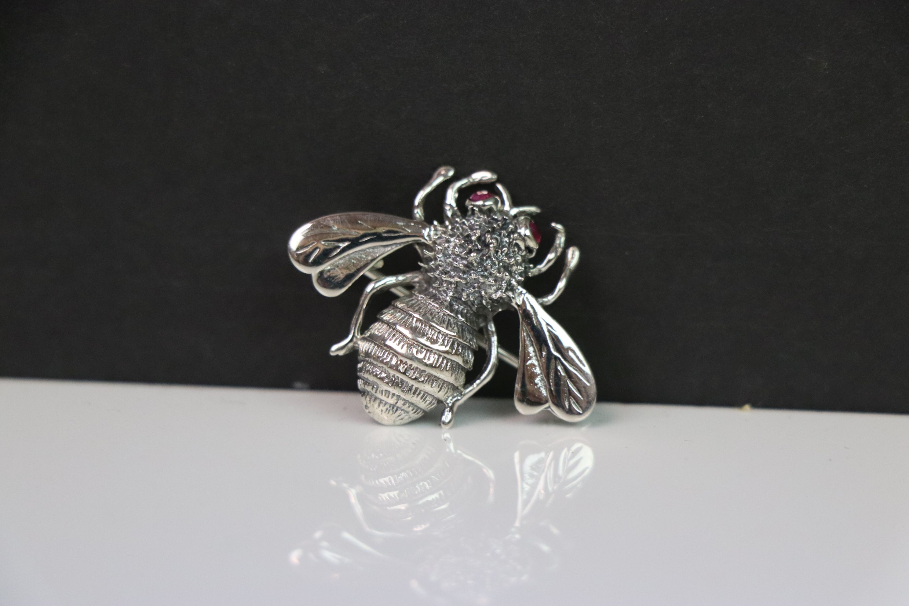Silver bee brooch with ruby eyes