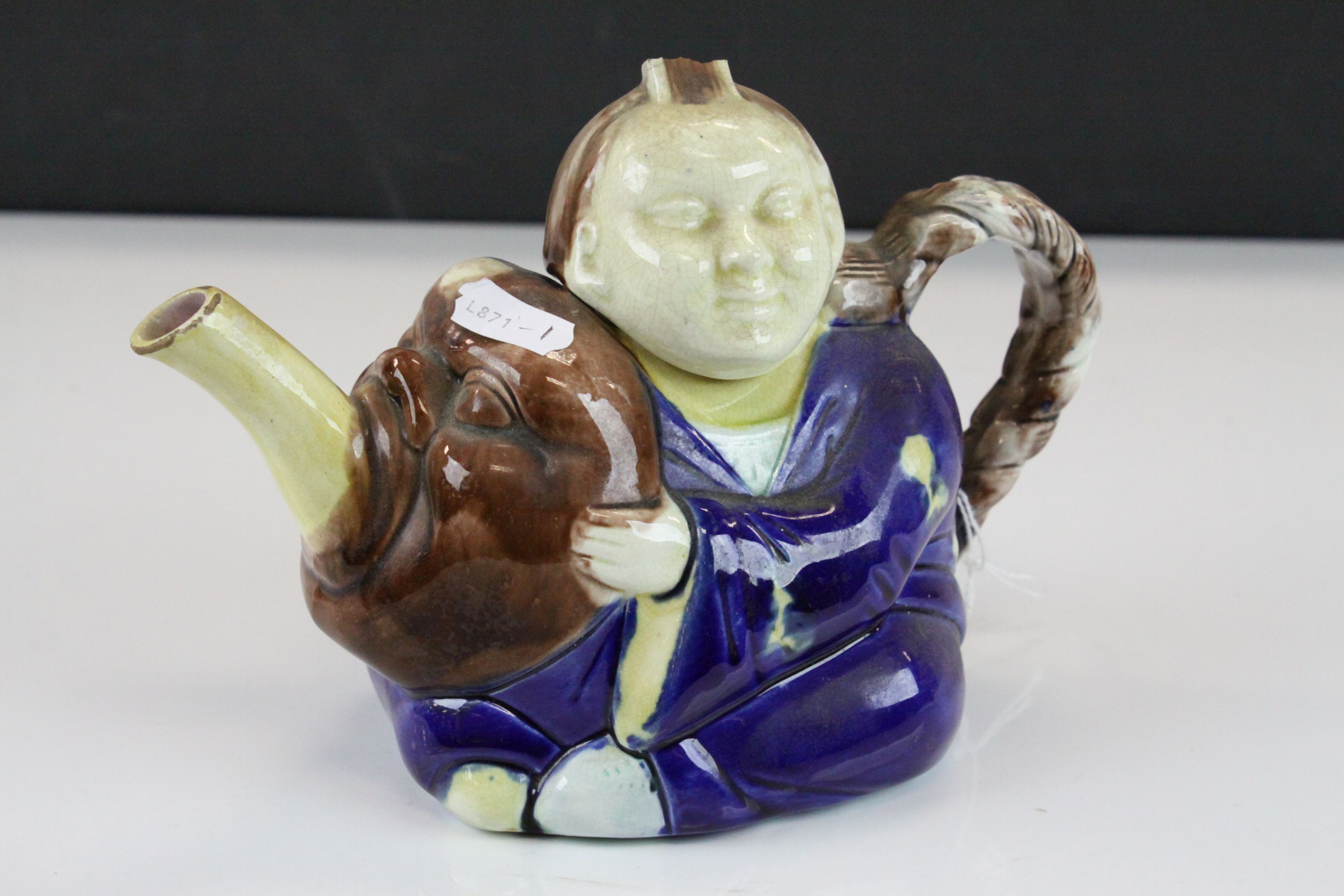 Majolica Teapot, designed as an Oriental figure, approx 21.5cm long, marked "A" to base