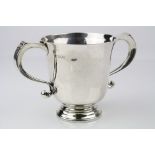 Silver twin handled cup, plain polished body raised on circular moulded foot, scroll handles with