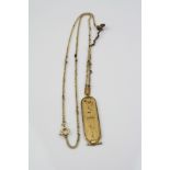 Egyptian gold pendant necklace, the pendant and bale with hieroglyphic decoration, length
