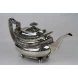 George III silver tea pot raised on four ball feet, repeating bead decoration, gadrooning to upper