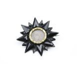 Early Victorian French jet yellow metal star brooch, sixteen star rays, hair panel to centre with