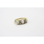 Victorian opal and diamond ring, three cabochon cut precious white opals displaying violet, green