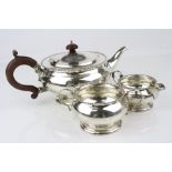 George V silver three piece tea service comprising tea pot, twin handled sugar bowl and milk jug,