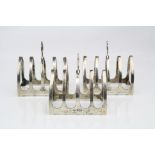 Three matched silver five bar toast racks of arched form, makers Viner's Ltd, Sheffield 1933, 1937