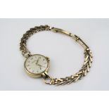 Ladies 9ct yellow gold cased wristwatch, champagne dial and subsidiary dial, gilt Arabic numerals