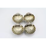 Set of four Victorian silver shell shaped salts each raised on three ball feet, makers Mitchell