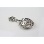 Edwardian Scottish silver caddy spoon, the heart shaped bowl with repoussé courting couple scene,