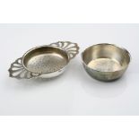 Continental silver tea strainer and base, the handles of openwork design, London import marks for