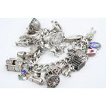 Silver curb link charm bracelet with padlock clasp and twenty silver and white metal charms