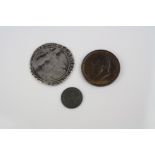 A small collection of three coins to include an Elizabeth I silver Hammered Coin, A Lundy Half