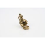 9ct gold charm, modelled as a snake charmer, length approximately 2cm